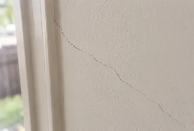 Hairline crack running through painted plaster wall in an Australian home