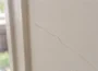 Hairline crack running through painted plaster wall in an Australian home